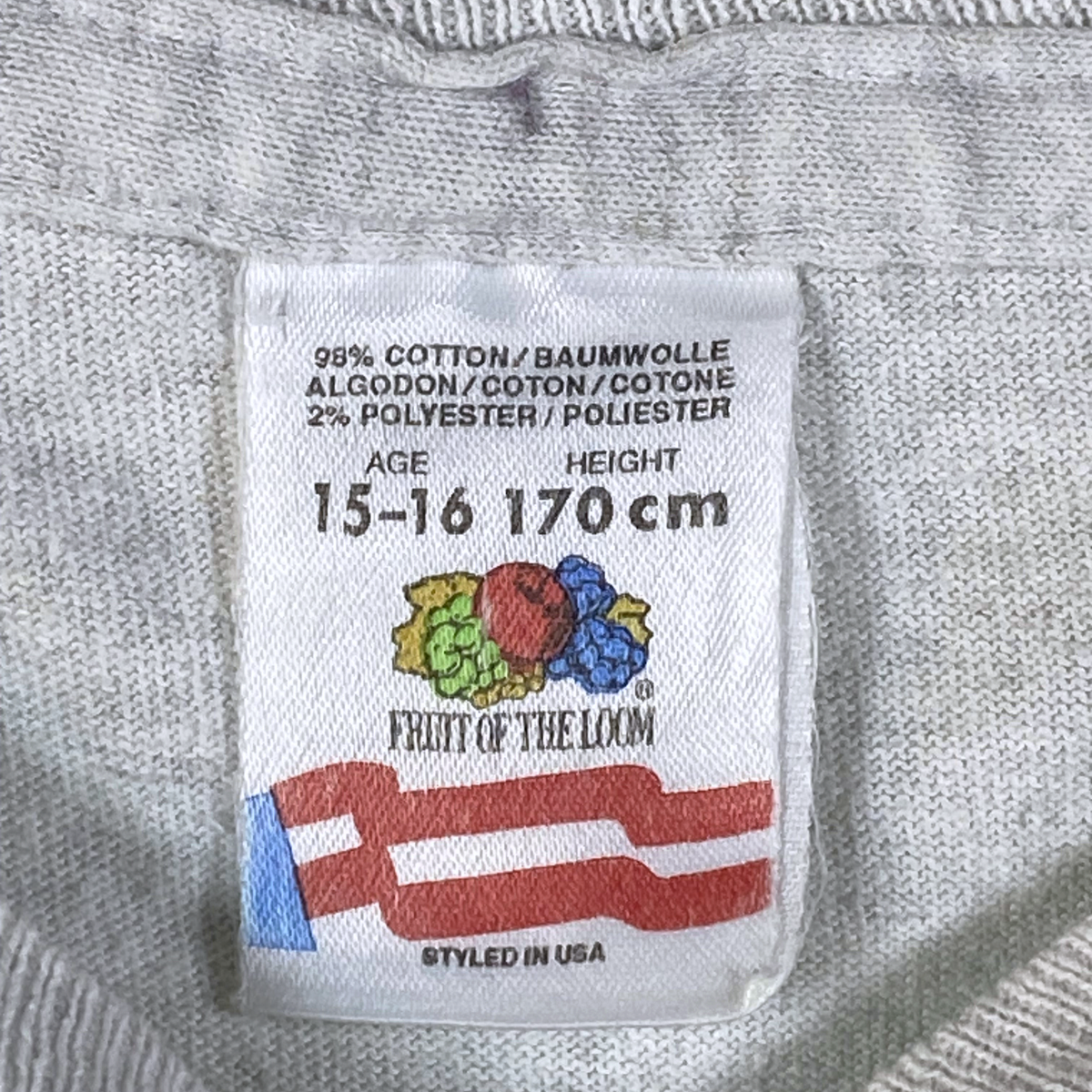 Digg It Thrift & Vintage Fruit of the Loom grey t-shirt care label showing cotton polyester blend and size details
