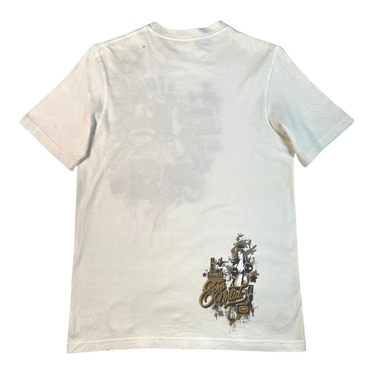 A white short-sleeve t-shirt shown from the back, featuring a faded gray graphic print on the upper back and a distressed graphic with the text 'The Outfitter' in gold and black near the lower right hem.