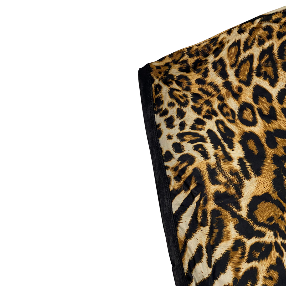 Digg It Thrift & Vintage leopard print poncho top with black trim and rhinestone detailing on a plastic surface