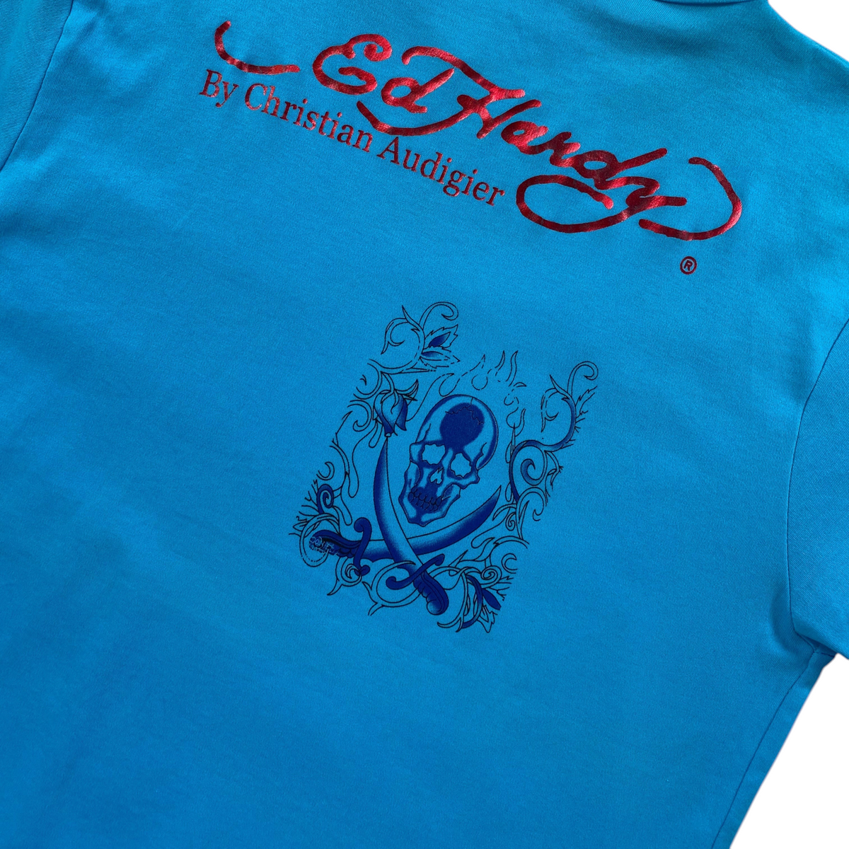 Digg It Thrift & Vintage turquoise Ed Hardy t-shirt featuring a red metallic logo and a blue skull and swords graphic