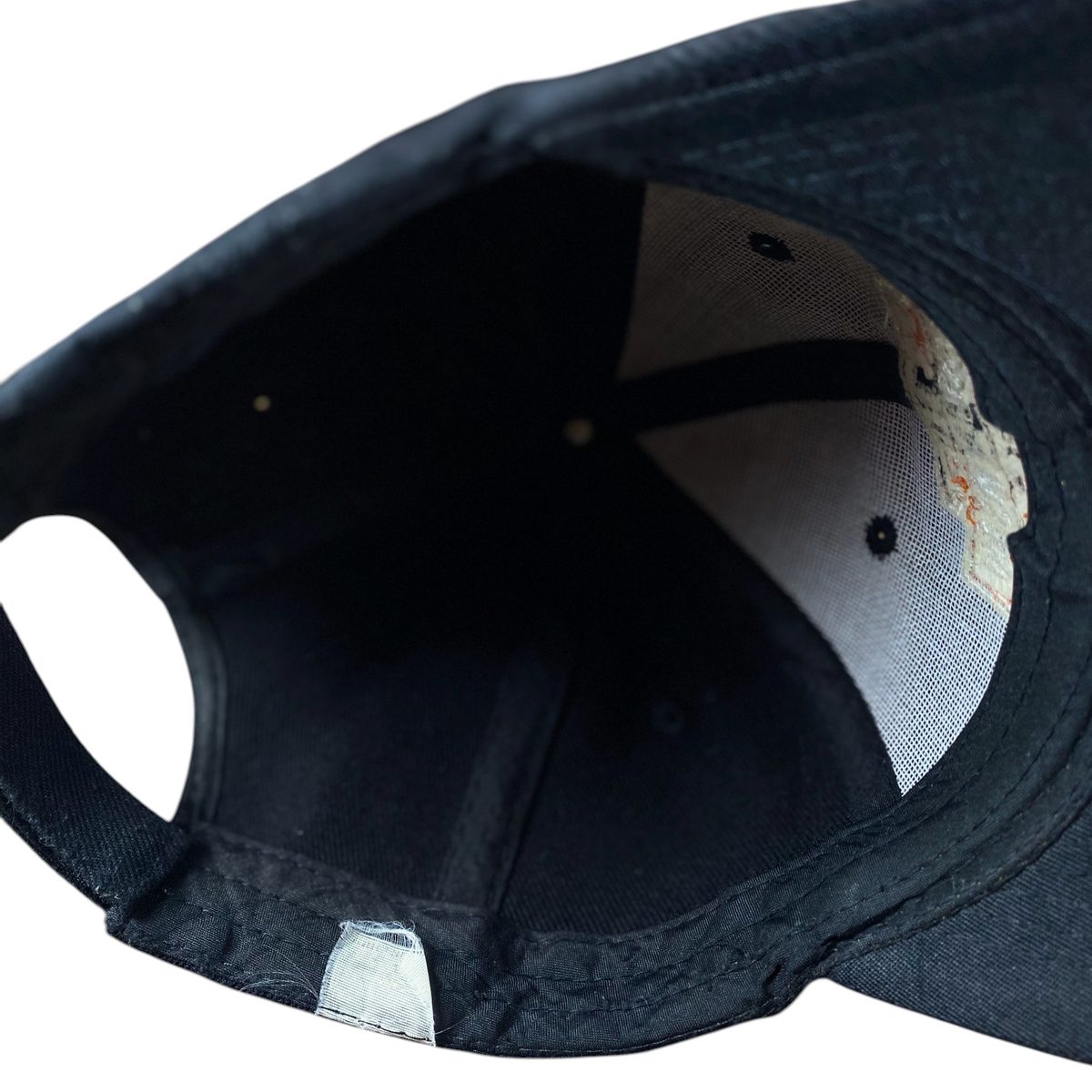 Interior view of a black Digg It Thrift & Vintage Harley-Davidson baseball cap showing the mesh lining and tags.