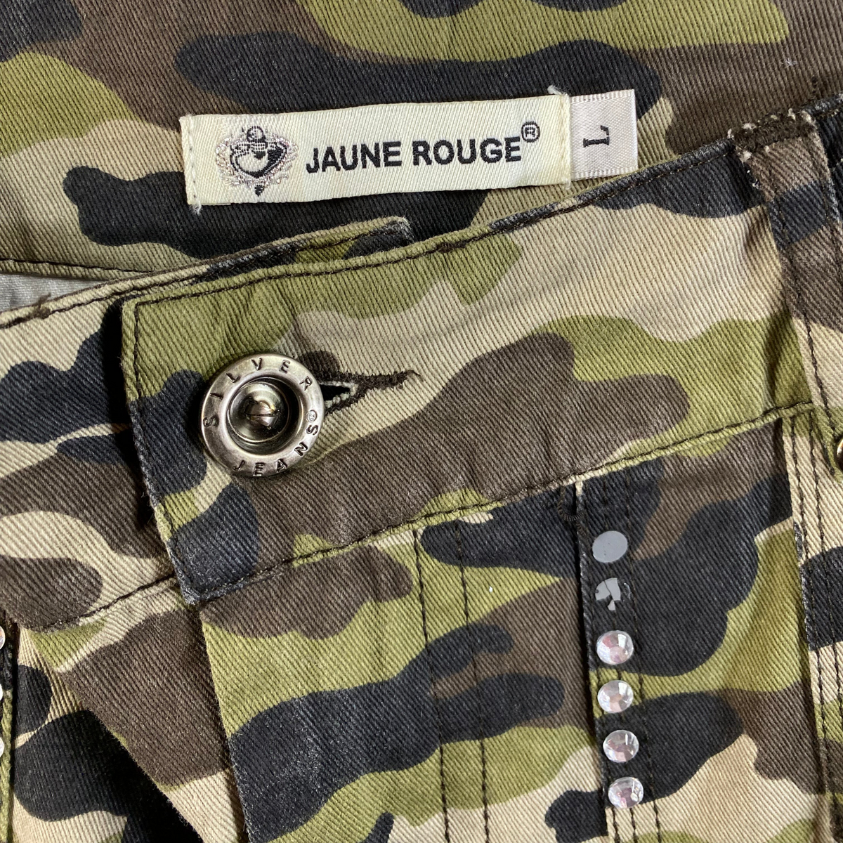 Digg It Thrift & Vintage Jaune Rouge camouflage pleated mini skirt with rhinestone studs and silver button detail