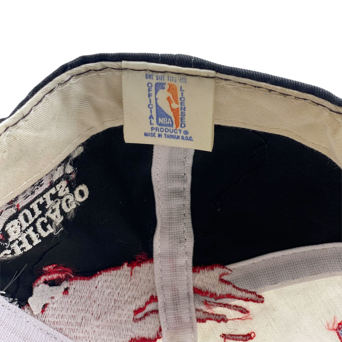 Digg It Thrift & Vintage 90s Chicago Bulls cap interior tag showing official NBA licensed product branding