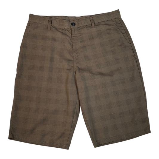 Digg It Thrift & Vintage khaki Dickies longline shorts featuring a subtle shadow plaid pattern and button closure.