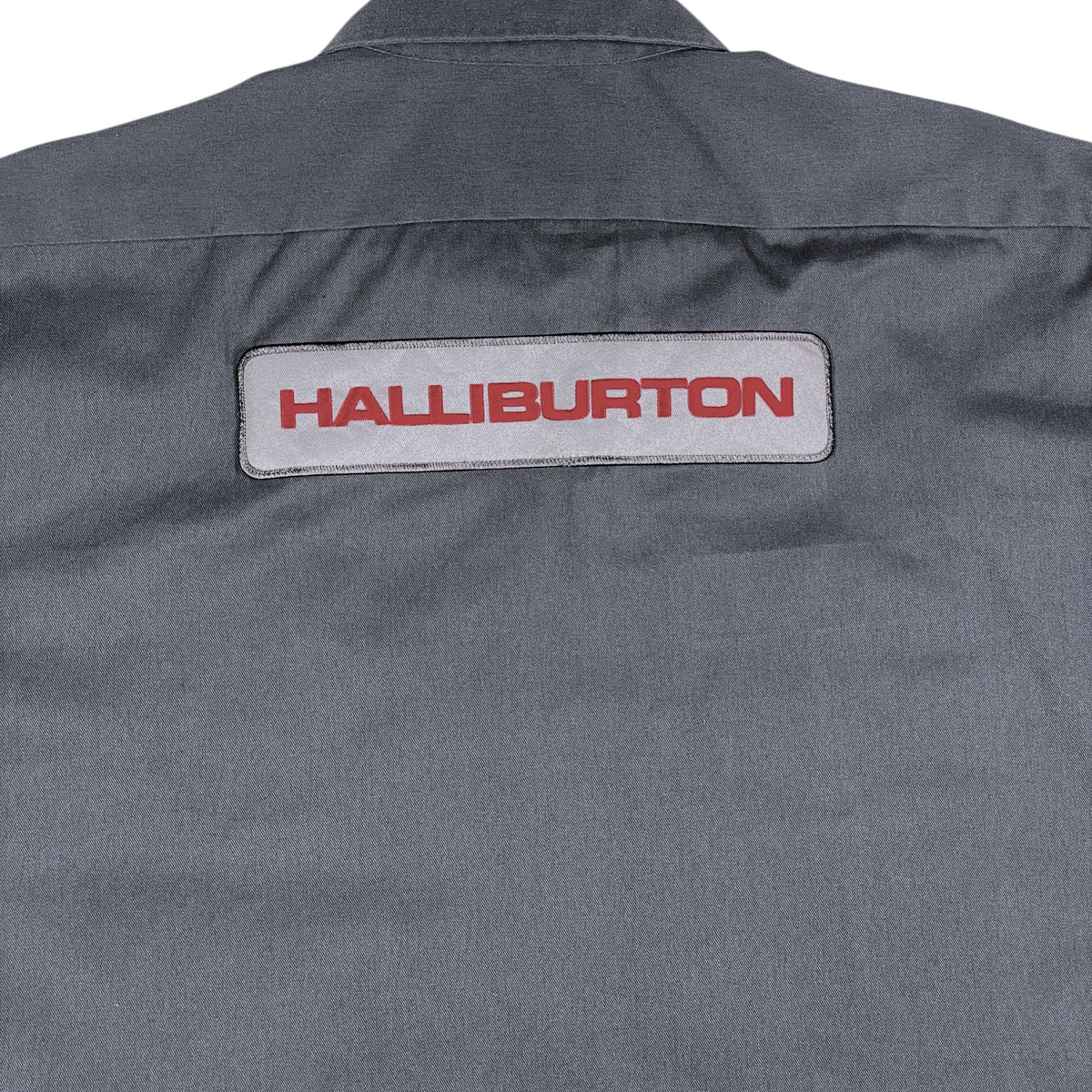 Digg It Thrift & Vintage gray Dickies work shirt featuring a Halliburton patch on the back