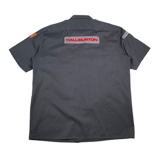 Back view of a gray Digg It Thrift & Vintage Dickies Halliburton work shirt with red logo embroidery and patches.