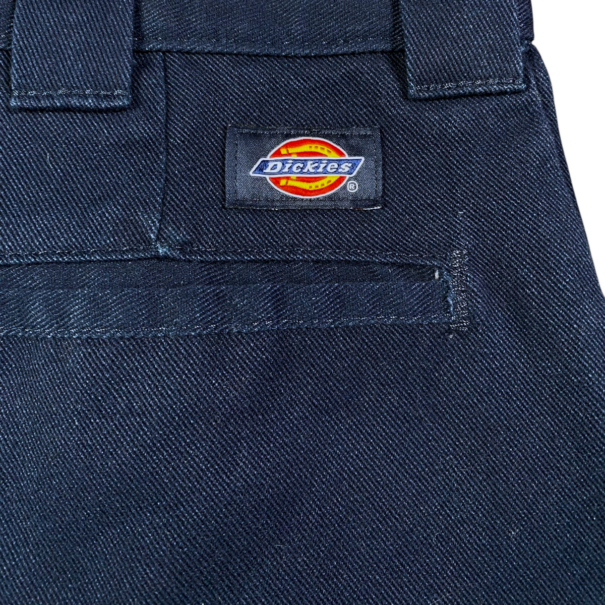 Digg It Thrift & Vintage navy blue Dickies 874 Flex work pants featuring the iconic brand logo patch on the back pocket