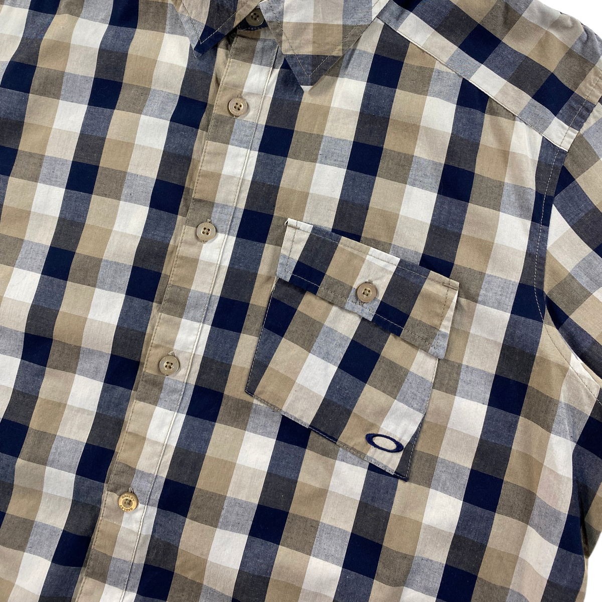 Digg It Thrift & Vintage Oakley beige and navy plaid short sleeve button-up shirt with chest pocket
