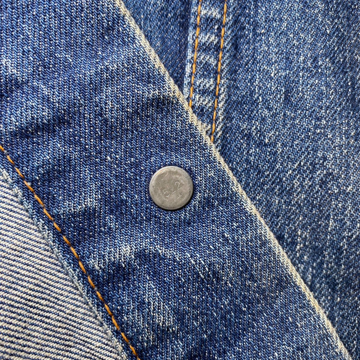 Close-up of a vintage Digg It Thrift & Vintage 1970s Levi's denim jacket button with visible stitching detail