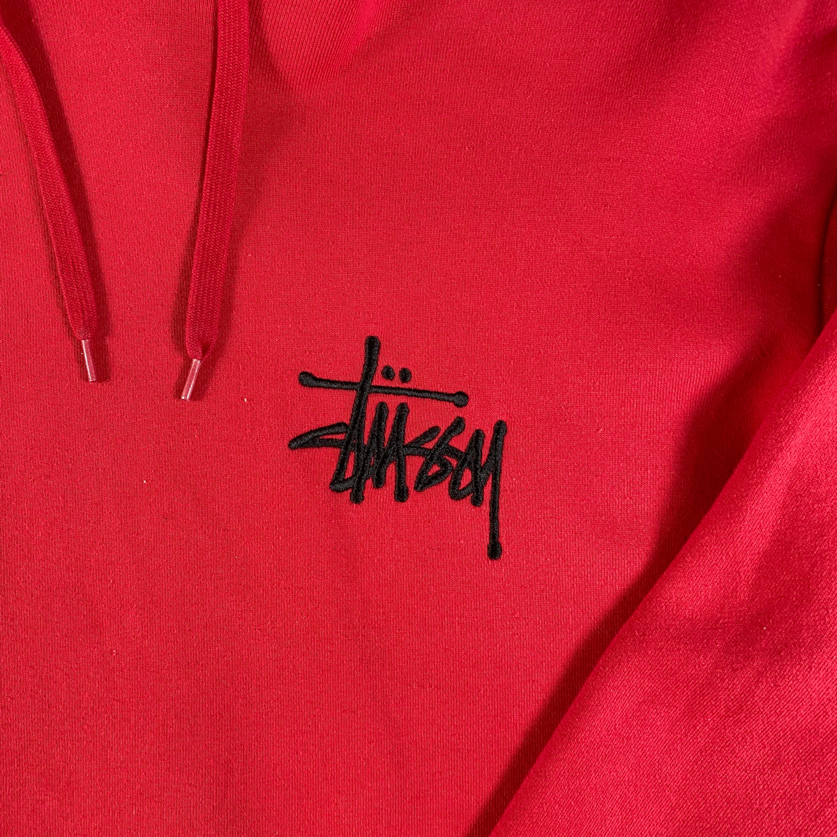 Digg It Thrift & Vintage red Stüssy pullover hoodie featuring a black embroidered logo on the chest