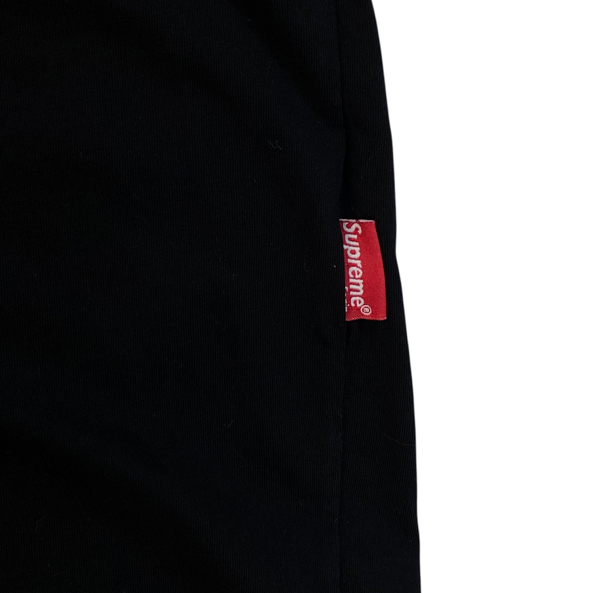 Digg It Thrift & Vintage black t-shirt featuring a red Supreme box logo side tab label