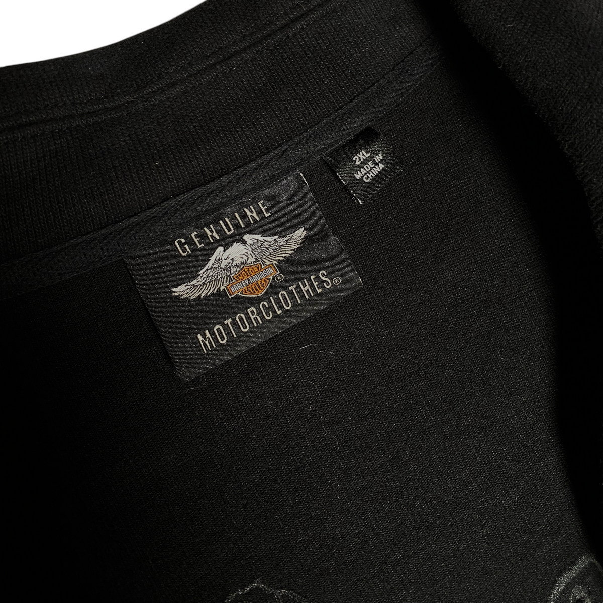 Digg It Thrift & Vintage black Harley-Davidson MotorClothes label with 2XL size tag on a cotton cardigan