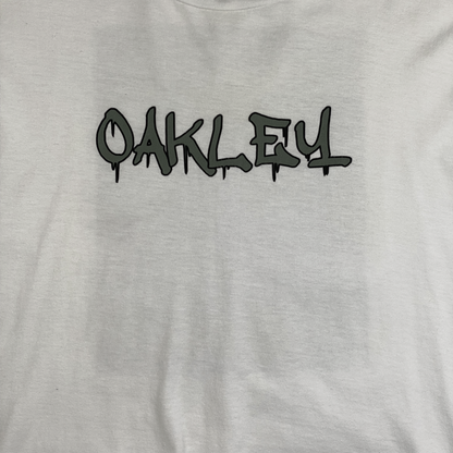 Digg It Thrift & Vintage white Oakley t-shirt featuring a green graffiti-style logo on the front
