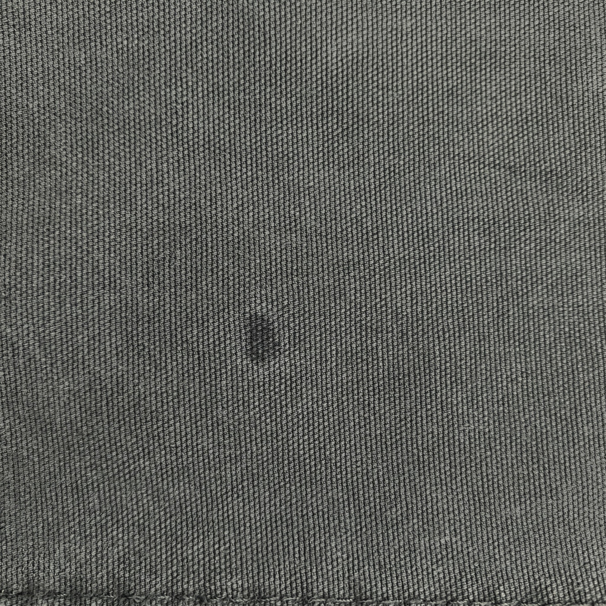 Close-up of dark green fabric on Digg It Thrift & Vintage Dickies pants showing texture and a small spot
