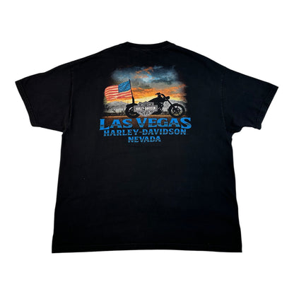 A black short-sleeve t-shirt with a graphic print on the back featuring a motorcycle, an American flag, and the text 'LAS VEGAS HARLEY-DAVIDSON NEVADA' in blue and white.