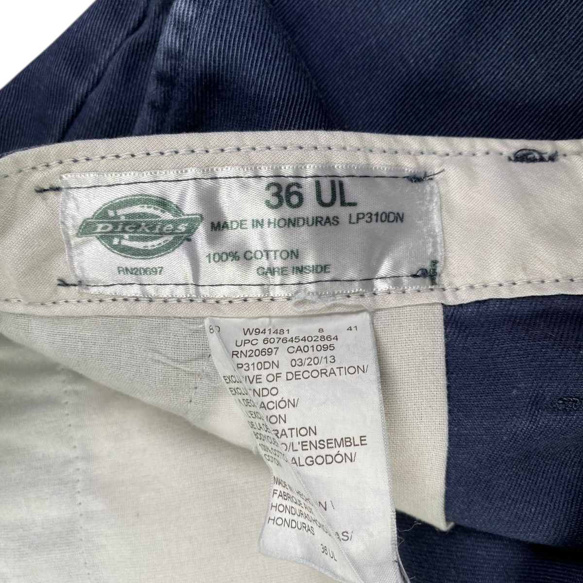 Digg It Thrift & Vintage Dickies Insect Shield navy pants interior tag showing size 36 and 100 percent cotton fabric