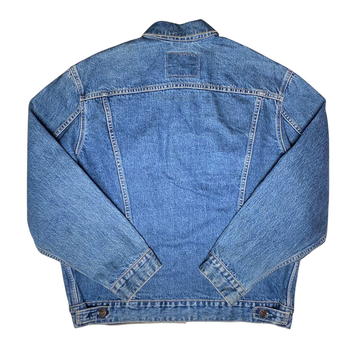 Back view of a vintage blue denim Levi's Trucker Jacket from Digg It Thrift & Vintage with classic stitching.