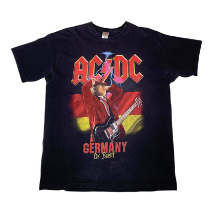 A vintage AC/DC band t-shirt featuring the 'Germany of Pain' album artwork. The black short-sleeve t-shirt displays the red and pink AC/DC logo, a graphic of a guitarist in a red jacket against a German flag, and the text 'GERMANY OF PAIN' in red and yellow.