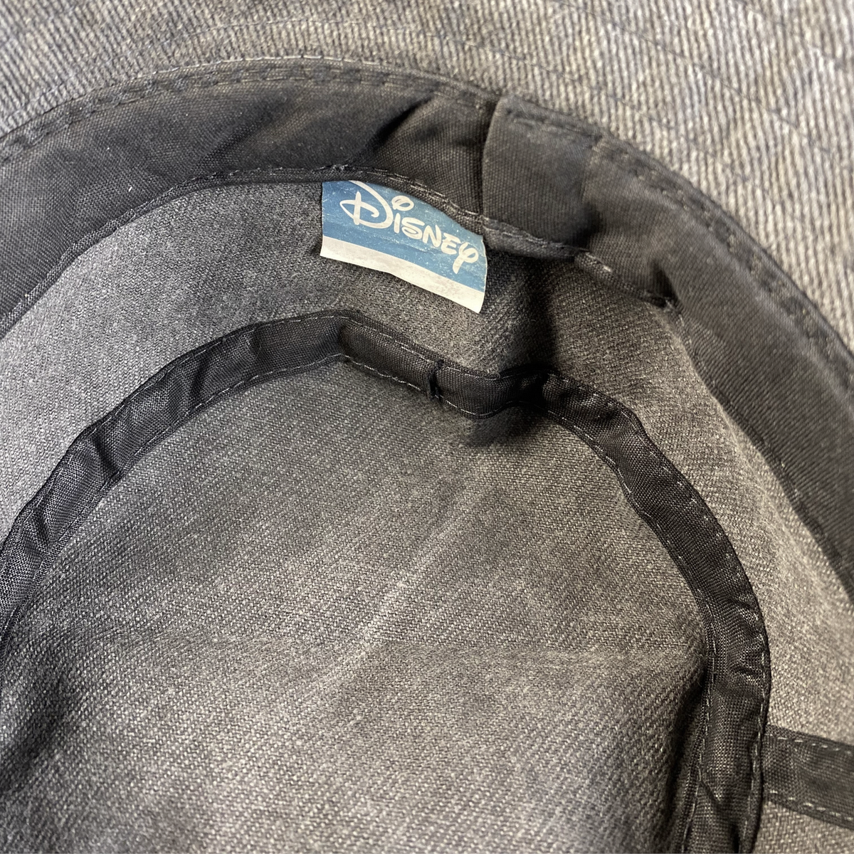Digg It Thrift & Vintage grey acid-wash denim bucket hat with official Disney interior brand label