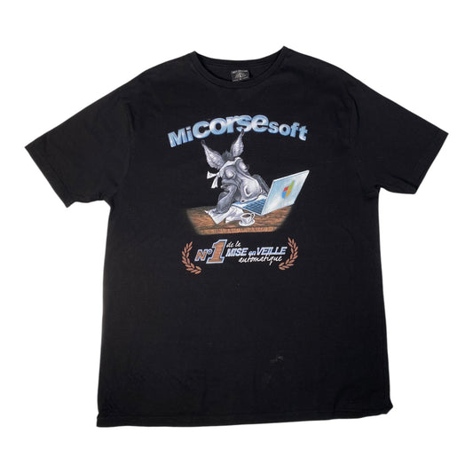 A black short-sleeve graphic t-shirt featuring a cartoon rabbit sitting at a laptop with the text 'MiCorsesoft' above and '1er Prix de la Ville d'Amsterdam' below, displayed flat against a white background.