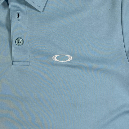 Digg It Thrift & Vintage light blue Oakley athletic golf polo shirt with a classic collar and button placket.