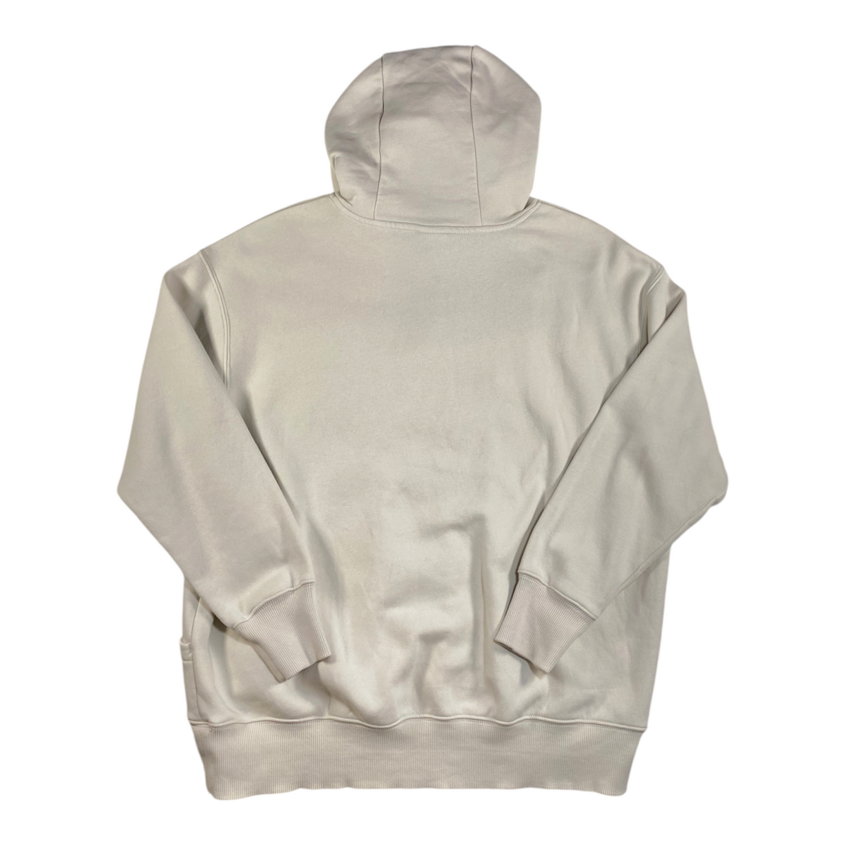 Back view of a cream Nike oversized pullover hoodie from Digg It Thrift & Vintage with ribbed cuffs and hem.