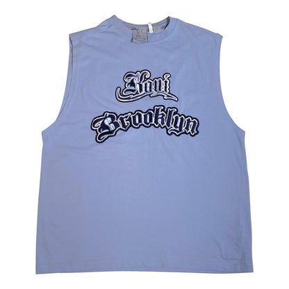 A light blue sleeveless muscle tank top featuring a stylized 'Now Brooklyn' graphic in black and white gothic font across the chest, displayed flat against a white background.