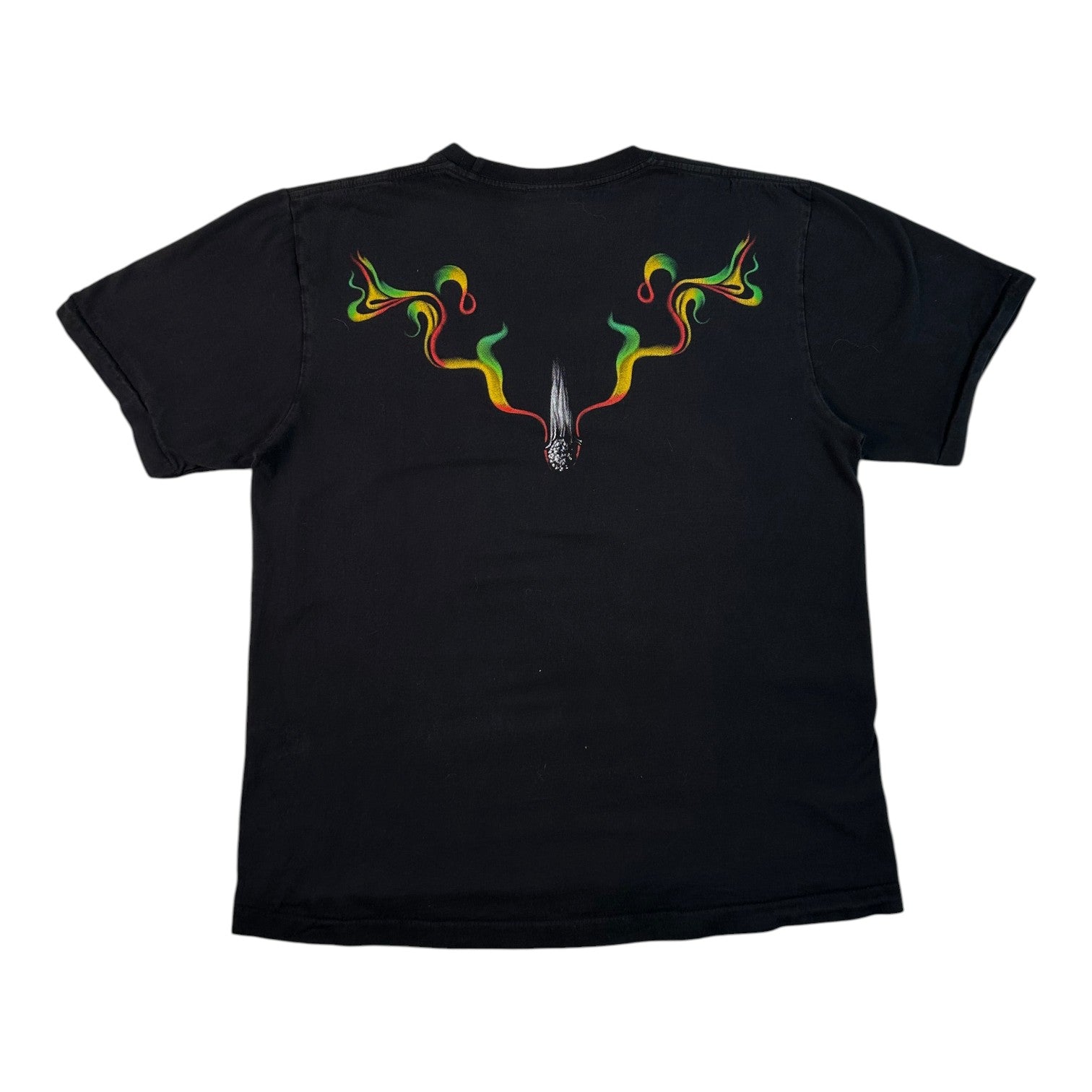 A black short-sleeve t-shirt shown from the back, featuring a graphic of a silver dagger surrounded by colorful smoke in green, yellow, and red, forming a V-shape above the dagger.