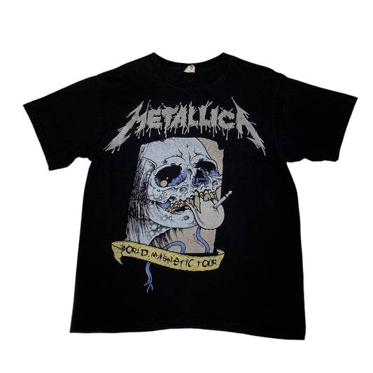 A black short-sleeve Metallica graphic t-shirt featuring the band's logo in white above a large skull illustration with a yellow banner reading 'World Tour 1996-1998'.