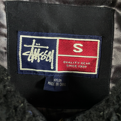 Digg It Thrift & Vintage Stüssy jacket interior label showing size small and nylon material composition