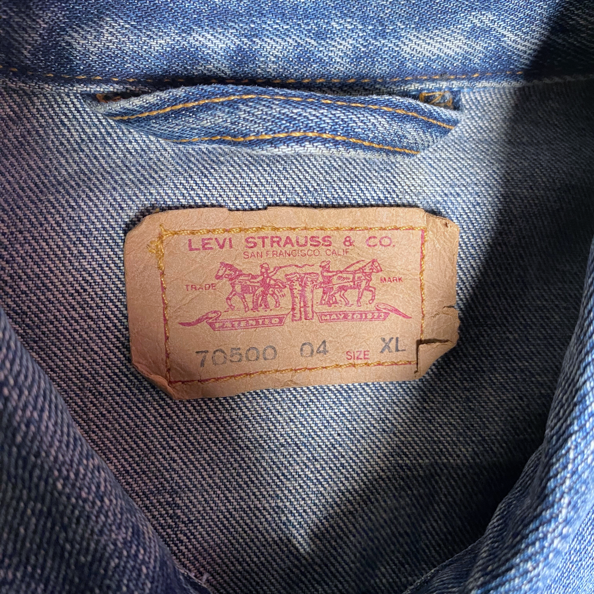 Digg It Thrift & Vintage Levi's denim trucker jacket neck label showing size XL and model 70500 on blue denim fabric
