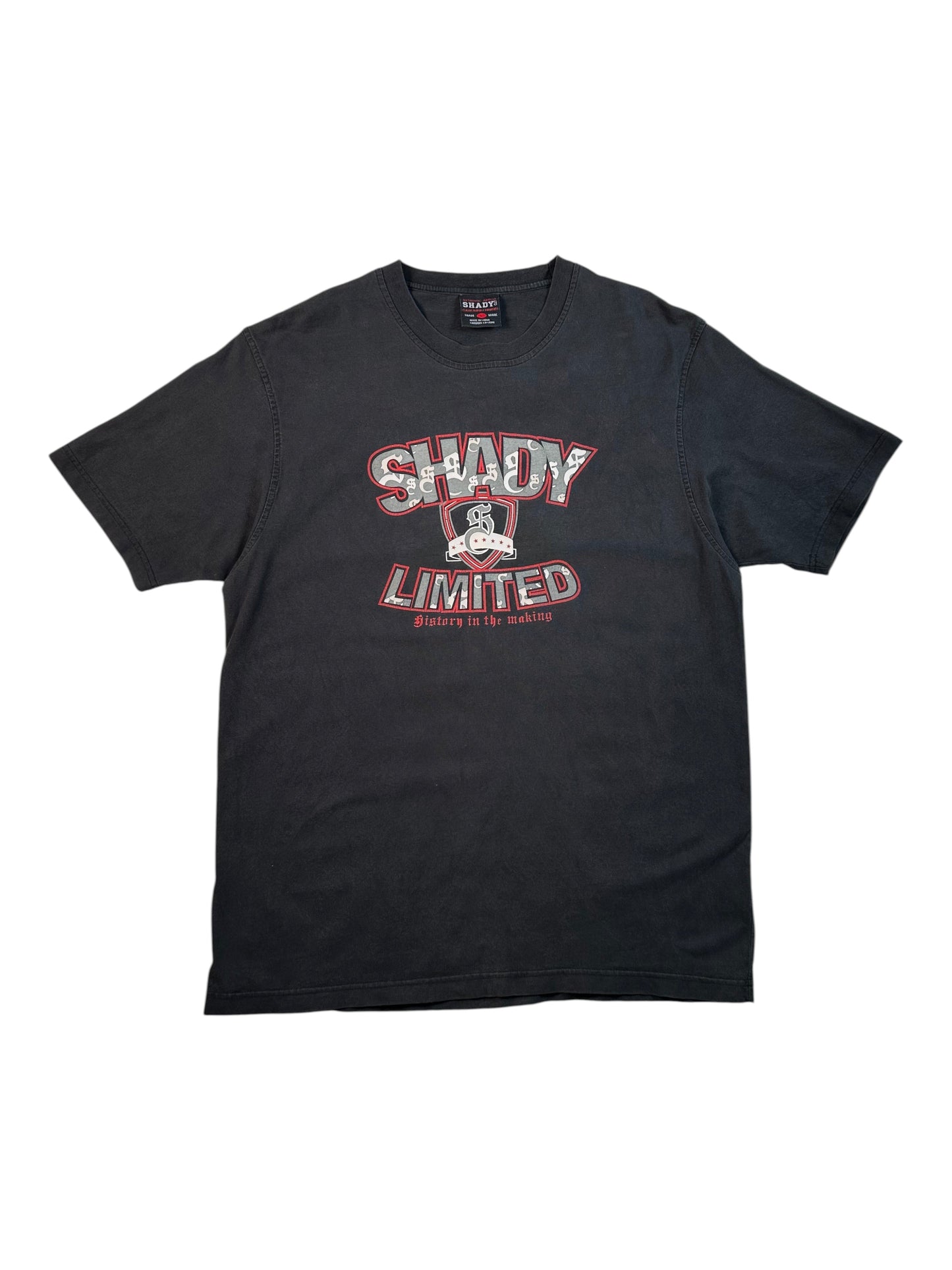A black short-sleeve t-shirt with a distressed graphic on the chest reading 'SHADY LIMITED' in red and white, featuring a small character graphic in the center, displayed flat against a white background.