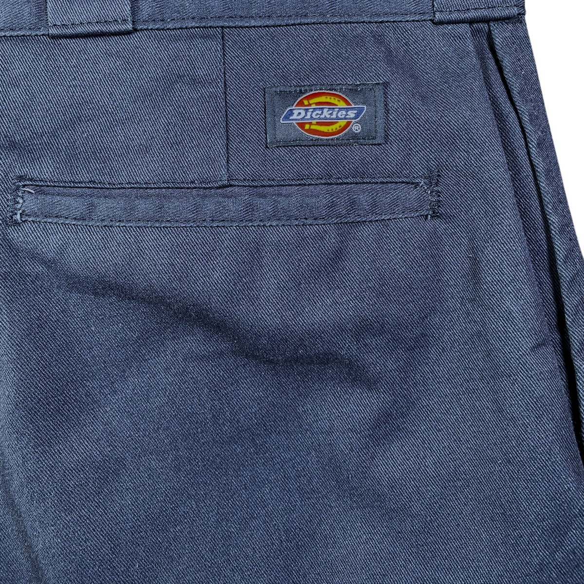 Digg It Thrift & Vintage navy blue Dickies 874 work pants featuring a rear pocket with the iconic Dickies logo patch