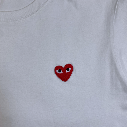 Digg It Thrift & Vintage white t-shirt featuring a small red embroidered heart with eyes on the chest
