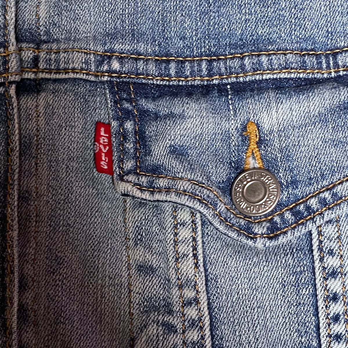 Digg It Thrift & Vintage Levi's denim trucker jacket with red tab and metal button detail