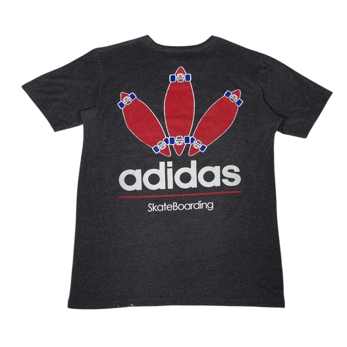A dark heather gray short-sleeve t-shirt featuring a graphic of three red skateboards arranged like bowling pins, with the white 'adidas' logo and 'SkateBoarding' text underneath.