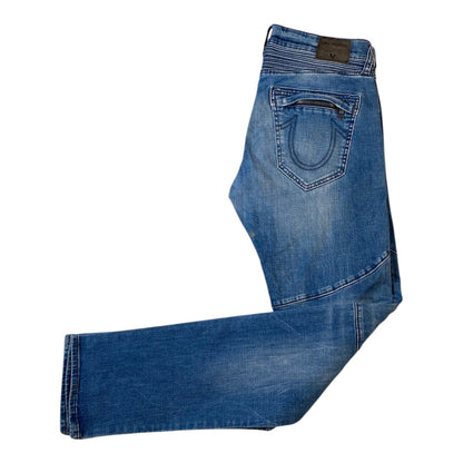 A pair of medium blue denim jeans shown from the back, featuring a zippered pocket on the right side and a brown leather brand patch at the waistband, laid flat on a white background.