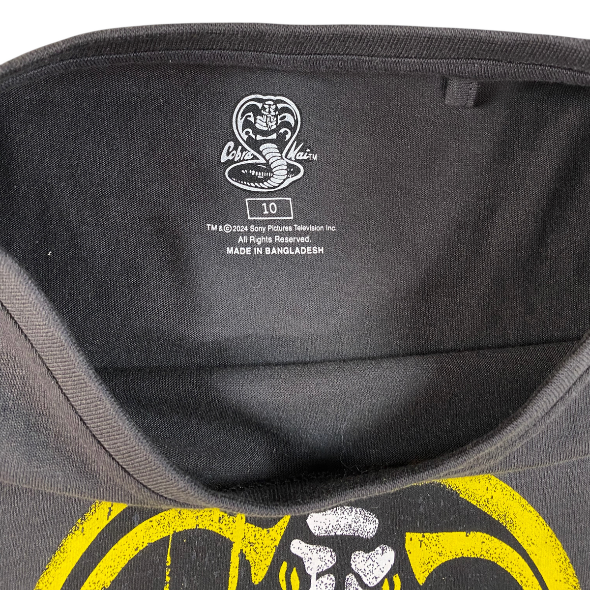 Digg It Thrift & Vintage charcoal grey Cobra Kai t-shirt interior neck label with size 10 tag