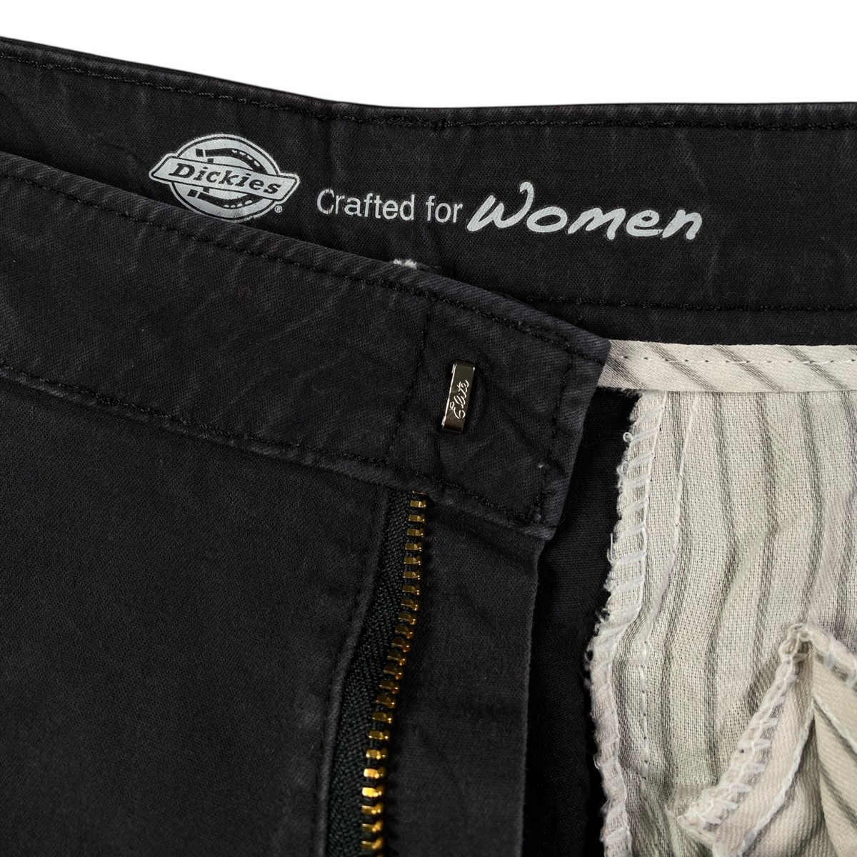 Digg It Thrift & Vintage Dickies women's dark grey pants featuring interior branding and a sturdy metal zipper