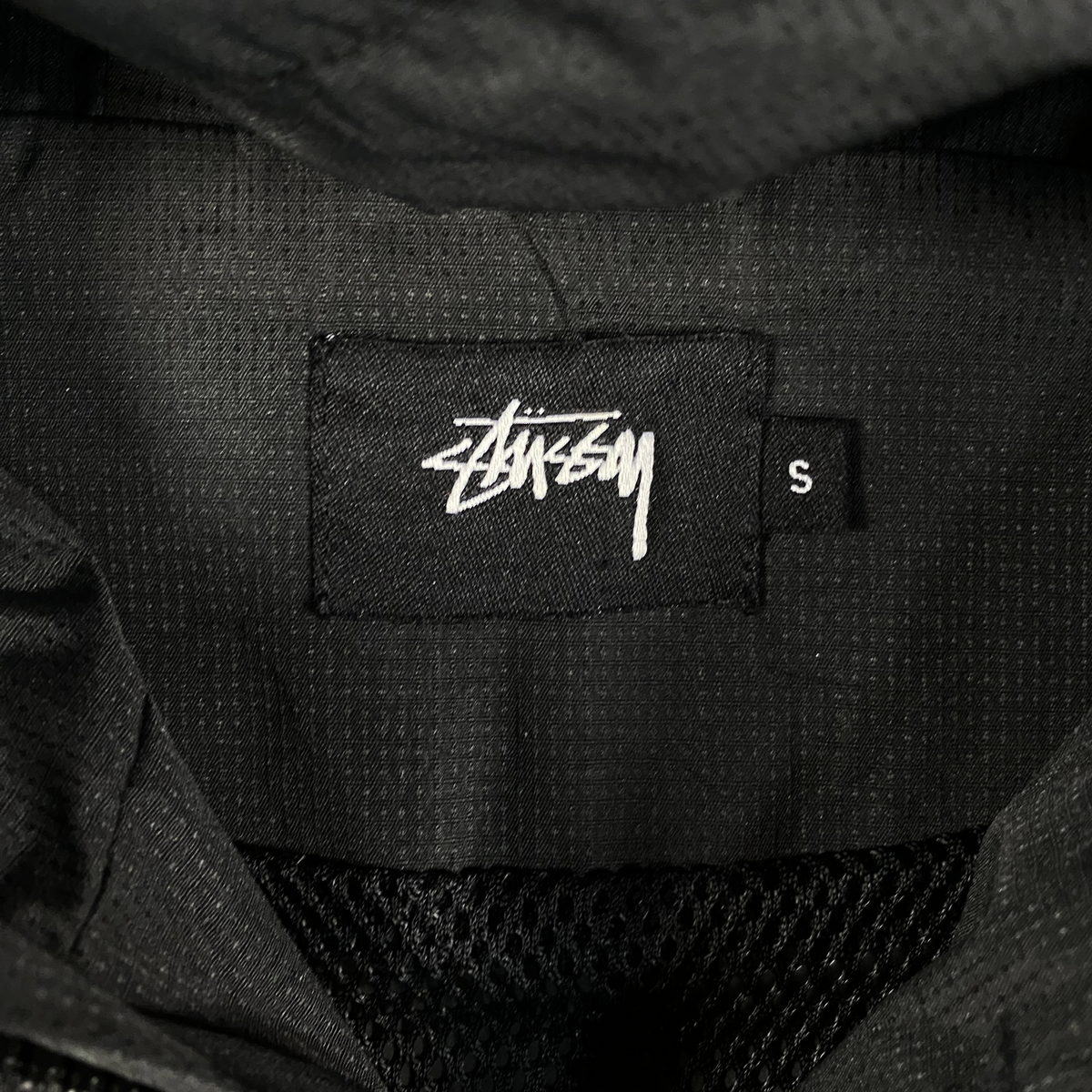 Digg It Thrift & Vintage Stüssy World Tour black windbreaker jacket interior label with size small tag