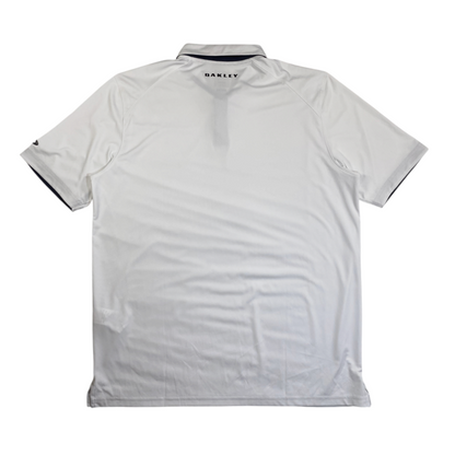 Back view of a white Oakley athletic golf polo shirt with navy blue collar trim from Digg It Thrift & Vintage