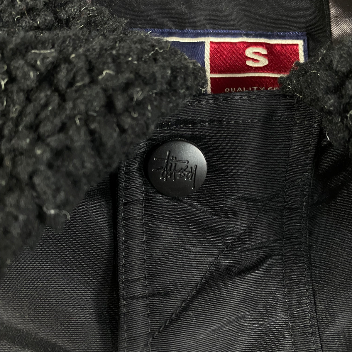 Digg It Thrift & Vintage black Stüssy insulated workwear jacket with a textured sherpa collar and branded snap button