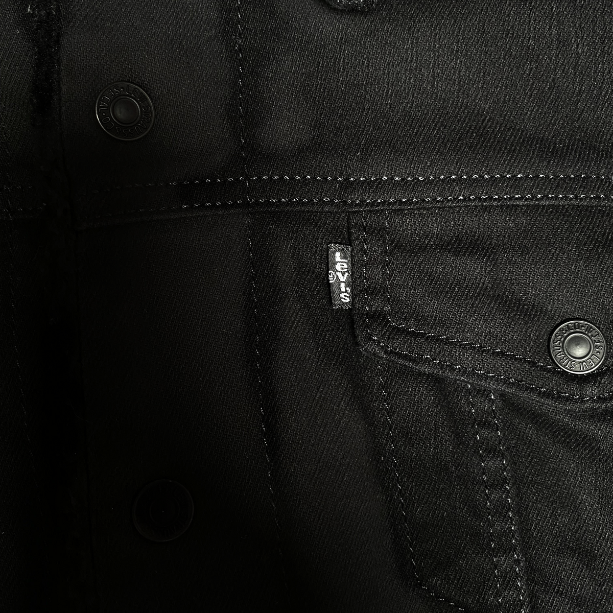 Digg It Thrift & Vintage black denim trucker jacket with sherpa lining and branded metal buttons