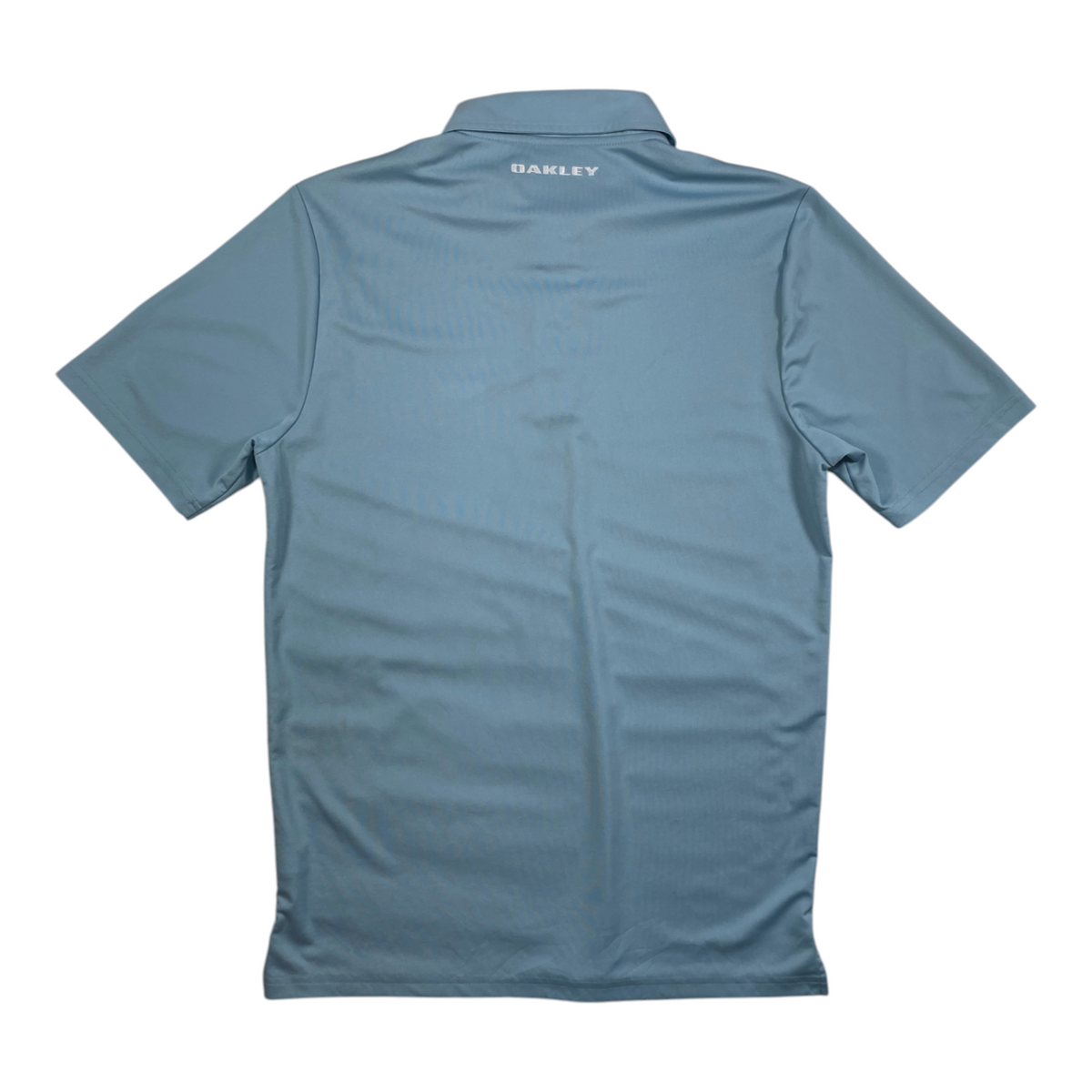 Back view of a light blue Oakley athletic golf polo shirt from Digg It Thrift & Vintage, size small.