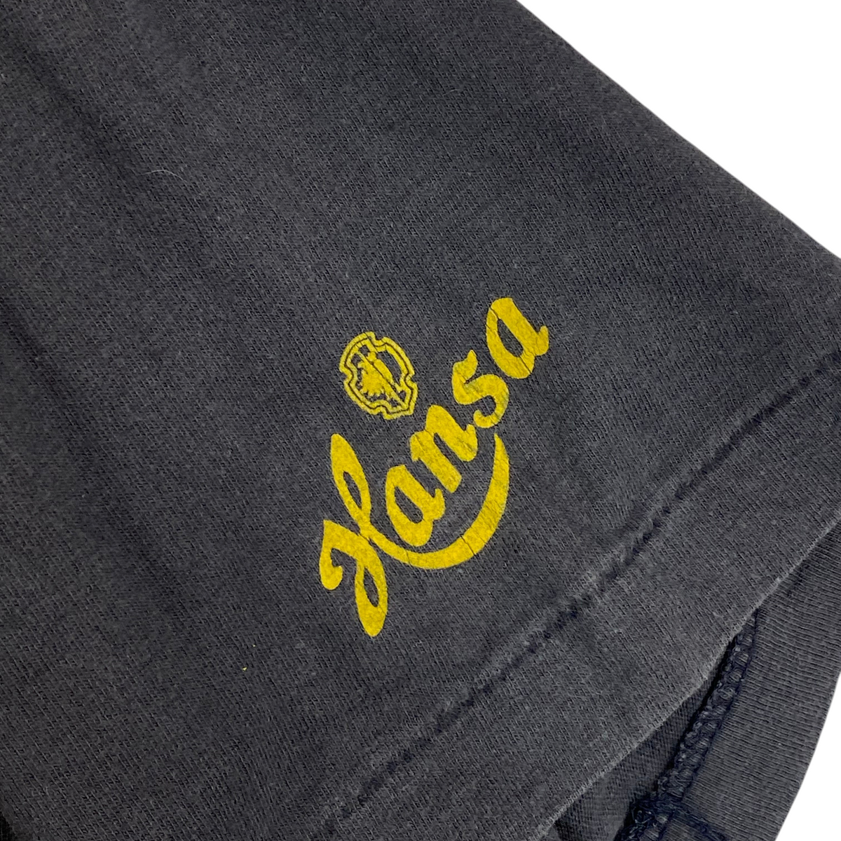 Digg It Thrift & Vintage faded black t-shirt sleeve with yellow Hansa logo print