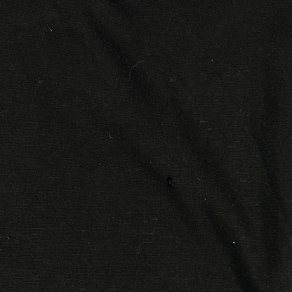 Digg It Thrift & Vintage black cotton fabric texture with a small hole detail from a vintage Asterix & Obelix shirt
