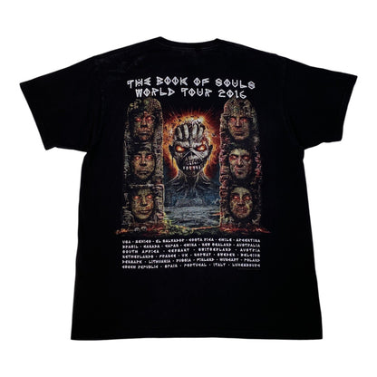 A black short-sleeve graphic T-shirt shown flat against a white background, featuring the back print for Metallica's 'The Book of Souls World Tour 2016' with a large central illustration and a list of tour cities below.