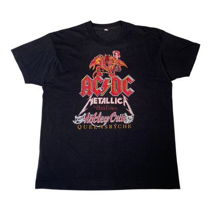 A black short-sleeve graphic t-shirt featuring the AC/DC Metallica 'Blind Eyes' show in Metz, France, printed on the front.