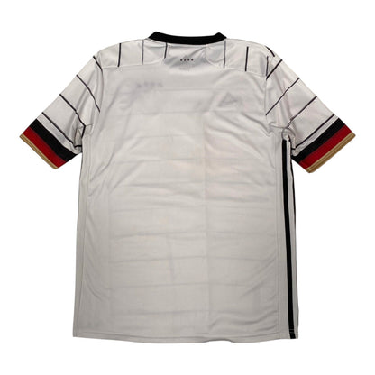 A white short-sleeve sports jersey with thin black stripes on the shoulders and sleeves, featuring a black collar and sleeve cuffs with red, black, and gold stripes, shown flat against a white background.