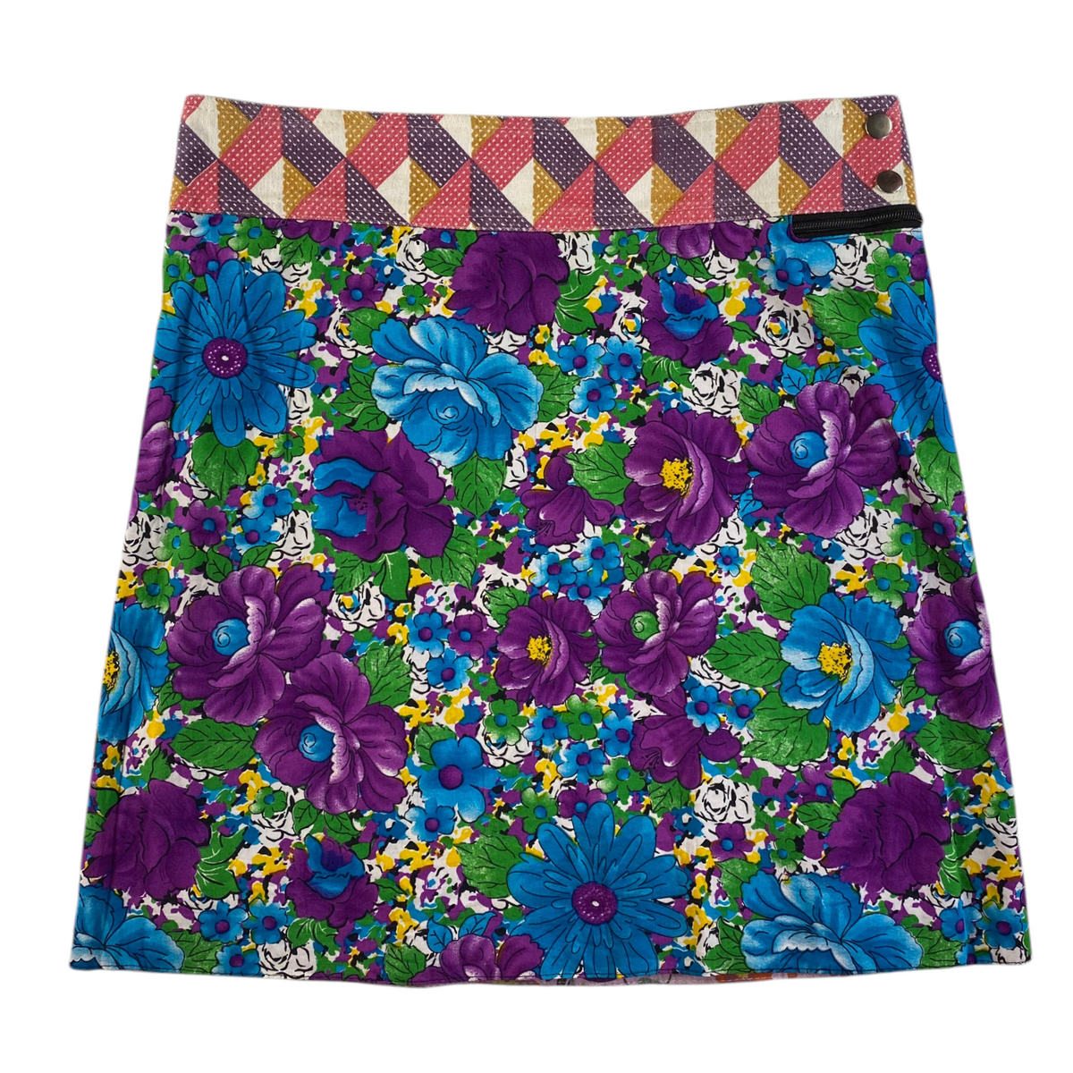 Digg It Thrift & Vintage reversible mini skirt featuring a vibrant floral and butterfly print with a geometric waistband